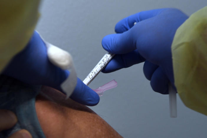 Tony Potts, a 69-year-old retiree living in Ormond Beach, Fla., receives his first injection earlier this year as a participant in a Phase 3 clinical trial of Moderna's COVID-19 candidate vaccine.
