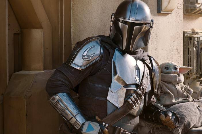 The Mandalorian (Pedro Pascal) and The Child in Season 2 of <em>The Mandalorian on </em>Disney+.