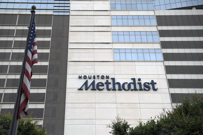 An American flag flies outside the Houston Methodist Hospital at the Texas Medical Center (TMC) campus in Houston, Texas.