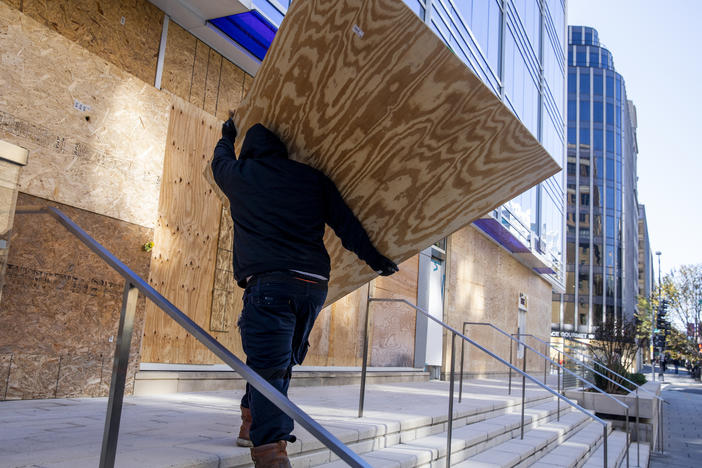 Workers board up a building in downtown Washington, D.C., in preparation for possible protests.