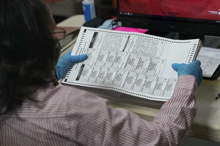 A county worker loads mail-in ballots into a scanner that records the votes at the Clark County Election Department last Thursday in Las Vegas.