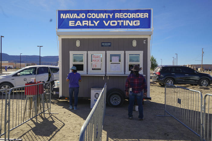 Navajo voters casting their ballots after riding 10 miles on horseback through Navajo County, Ariz.