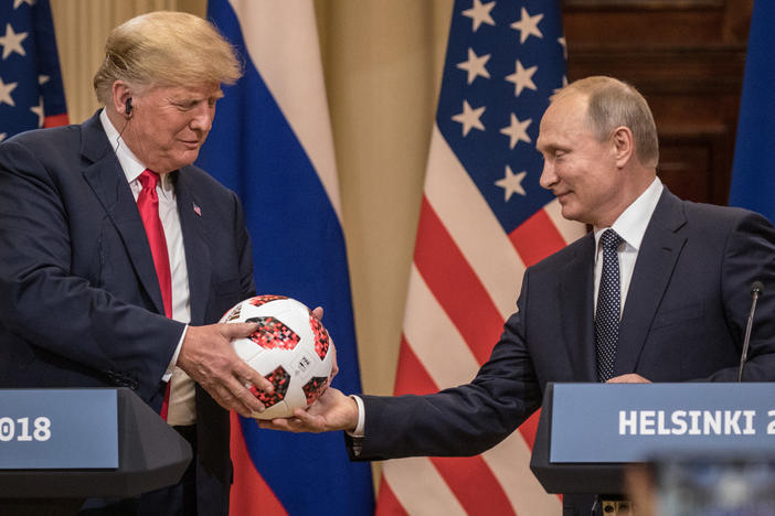 Russian President Vladimir Putin hands President Trump a World Cup soccer ball during a joint news conference after their July 2018 summit in Helsinki.