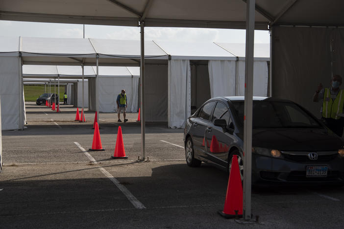 Voters drop off ballots last month at a drive-through polling place in Houston. Some 127,000 voters cast their ballots at drive-through locations in the Houston area.