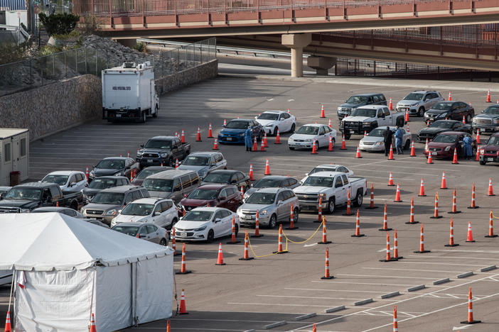 Cars wait in line at a coronavirus testing site at the University of Texas at El Paso Saturday. As El Paso reports record numbers of active coronavirus cases, the Texas attorney general sued to block local shutdown orders.