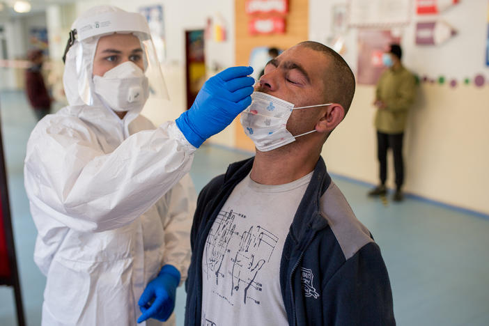 A man is tested for the coronavirus on Sunday in Košice, Slovakia, as part of a nationwide effort to test nearly everyone over age 10 for the virus.