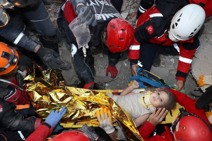Rescue workers carry Ayda Gezgin away from where she was trapped by rubble after a building collapsed during last week's earthquake in the Aegean port city of Izmir, Turkey.