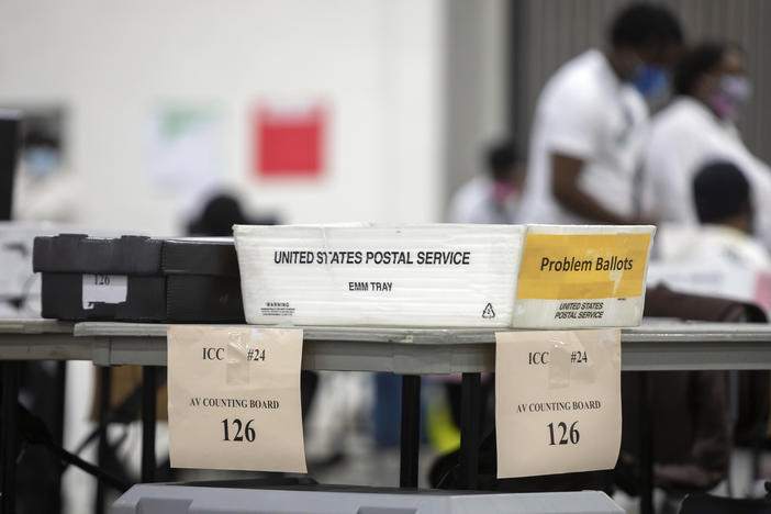 A problem ballot box is placed on the end of a table where workers with the Detroit Department of Elections sorts through absentee ballots.