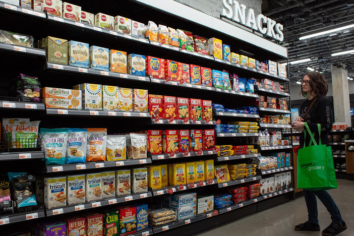 A pre-pandemic Seattle supermarket boasts row after row of prepackaged snacks. Even before the coronavirus pandemic put extra stress on grocery workers, keeping shelves stocked with the variety that Americans have come to expect took a hidden toll on producers, distributors and retail workers, says author Benjamin Lorr.