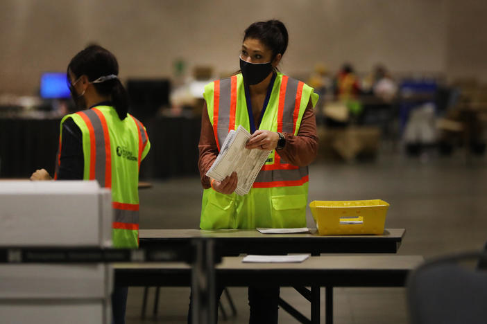Election workers in Philadelphia count ballots on Tuesday. Pennsylvania is among several swing states that have yet to be called.