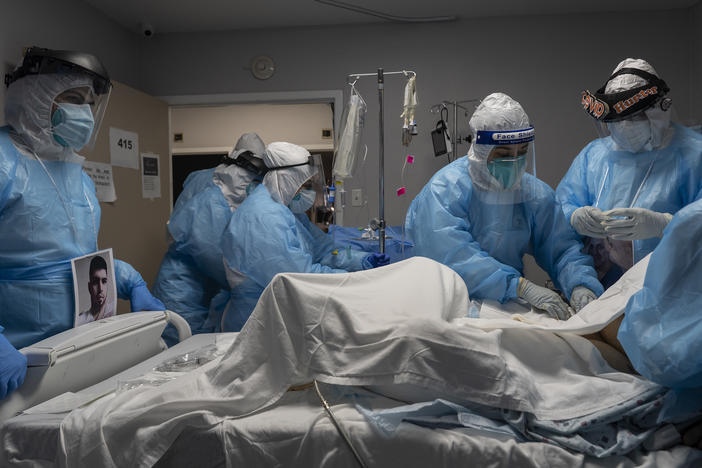 Medical staff members treat a patient with COVID-19 last week in the intensive care unit of United Memorial Medical Center in Houston. Once a COVID-19 vaccine is available, experts say immunizing health workers first is the best way to curb deaths and stop transmission.