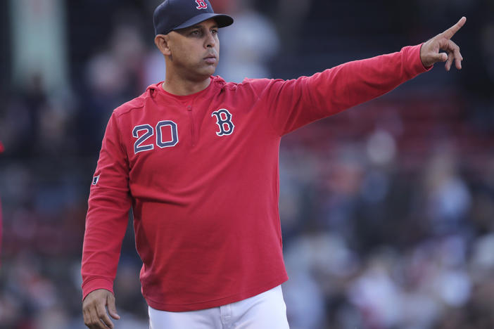The Boston Red Sox have reportedly rehired Alex Cora as the team's manager. He is seen above as he gestures toward the outfield after a win over the San Francisco Giants in a game at Fenway Park in Boston in 2019.
