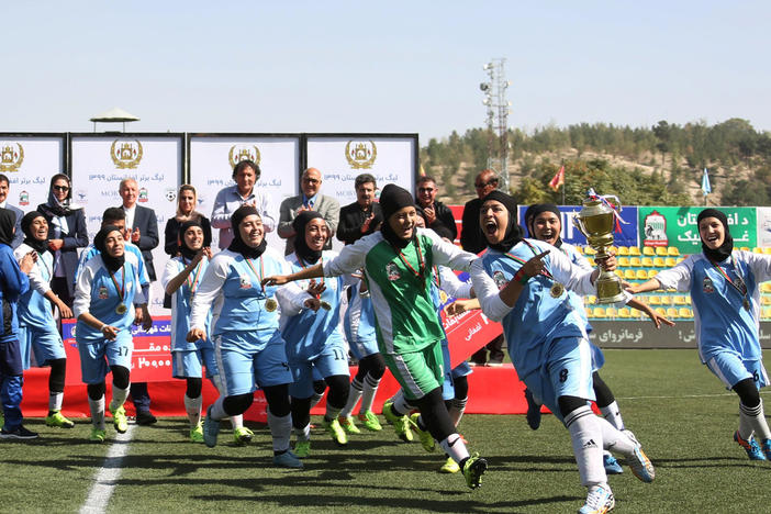 Players from the Herat Storm celebrate after winning the championship of the Afghan women's soccer league on October 16 in Kabul.