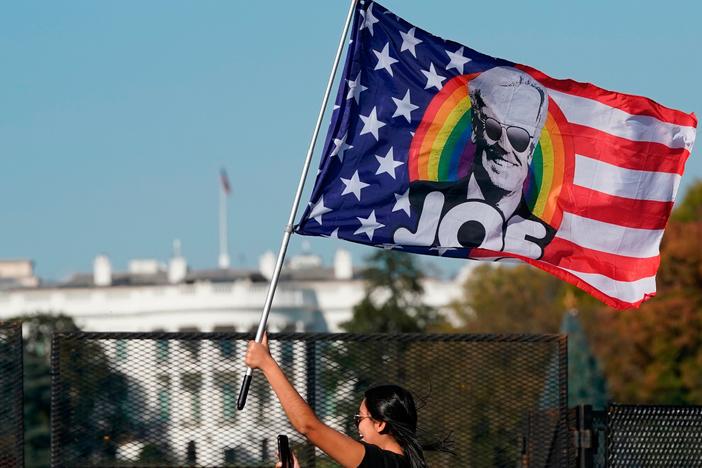 A woman waves a Joe Biden flag during celebrations of his presidential victory on Black Lives Matter Plaza across from the White House on Saturday.