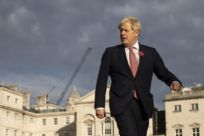 British Prime Minister Boris Johnson walks across Horse Guards Parade to Admiralty House on Friday in London.