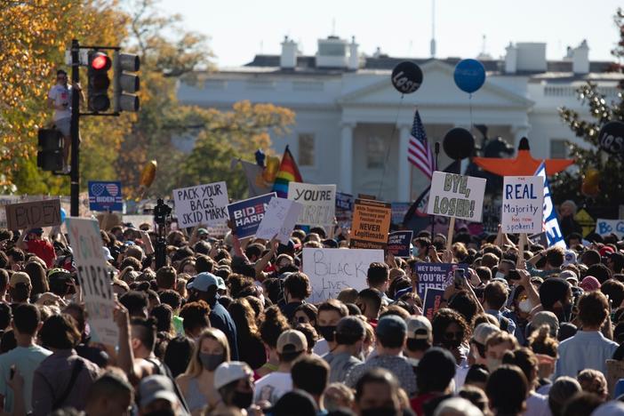 People celebrate Saturday at Black Lives Matter Plaza across from the White House in Washington, D.C., after Joe Biden was declared the winner of the 2020 presidential election.