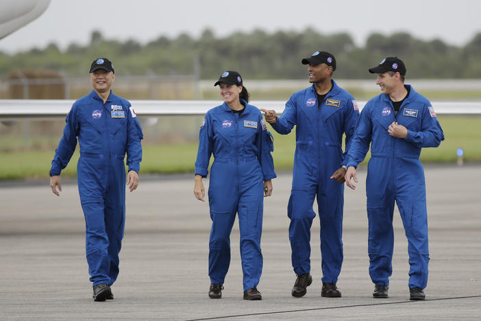 From left, astronaut Soichi Noguchi of Japan and NASA astronauts Shannon Walker, Victor Glover and Michael Hopkins walk after arriving at Kennedy Space Center in Cape Canaveral, Fla. The four astronauts will fly on the SpaceX Crew-1 mission to the International Space Station scheduled for launch on Saturday.