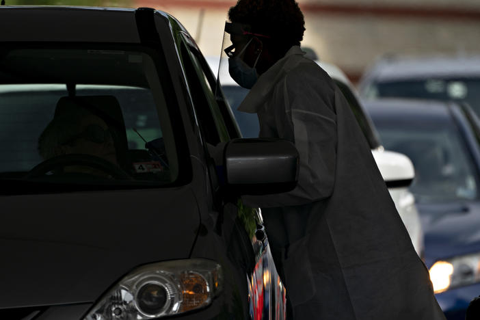 A coronavirus test is administered by a health care worker in Arlington, Va., on June 19.