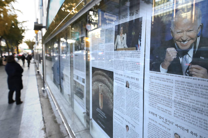 A newspaper's front page featuring President-elect Joe Biden and Vice President-elect Kamala Harris is displayed on a sidewalk in Seoul, South Korea, on Monday.
