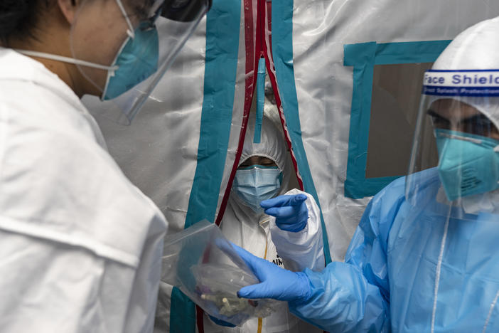 Medical staff members wear protective gear while working at the COVID-19 Intensive Care Unit at United Memorial Medical Center in Houston on Sunday.