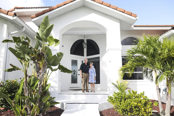 John and Mary Jane Forr stand outside their home in Punta Gorda, Fla. Forr, a retired Marine Corps colonel, discovered he could save $2,500 a year by shopping around for a lower-rate mortgage.