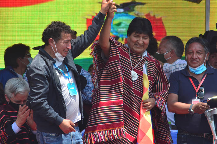 Former Bolivian President Evo Morales (middle) greets supporters during a welcoming ceremony after he crossed the border from Argentina after one year in exile on Monday, in Villazón, Bolivia.