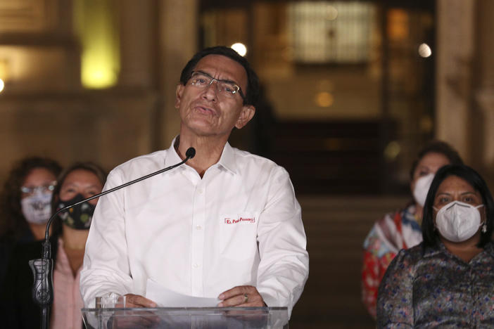 Peru's President Martín Vizcarra speaks in front of the presidential palace after lawmakers voted to remove him from office in Lima, Peru, on Monday. Peruvian lawmakers voted overwhelmingly to impeach Vizcarra, expressing anger over his handling of the coronavirus pandemic and citing unproven corruption allegations.