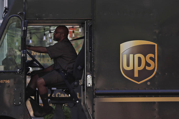 A UPS driver stops at a traffic light on April 24 in St. Louis. UPS employees are now allowed to grow their beards as the company loosens up on its appearance rules.