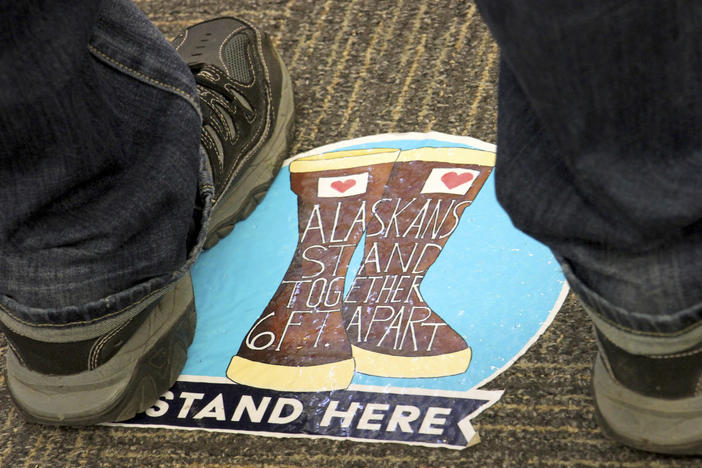 Social distancing floor stickers are seen at a mall last month during early voting in Anchorage, Alaska.