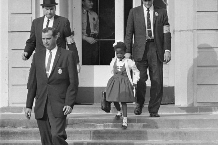 U.S. Deputy Marshals escort 6-year-old Ruby Bridges from William Frantz Elementary School in New Orleans, in this November 1960, file photo. Lucille Bridges, Ruby's mother, died Tuesday at the age of 86.