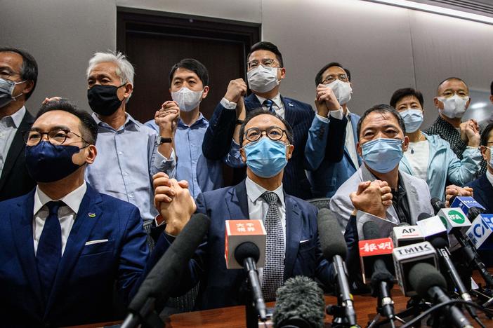Pro-democracy lawmakers at the start of a news conference in a Legislative Council office in Hong Kong on Wednesday. The legislators are resigning en masse over a new law from Beijing that led to the ouster of four of their fellow lawmakers.