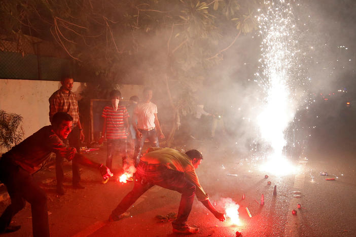 The fireworks of Diwali, the Hindu festival of lights, add smoke to the already polluted skies — and raise concerns about the impact of all that pollution on coronavirus cases. Here, a celebration takes place last year in Ahmedabad, India.