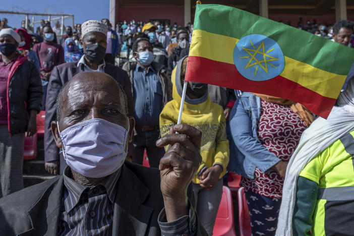A man holds a national flag as he waits to donate blood in support of Ethiopia's military in Addis Ababa on Thursday. Rallies occurred in multiple cities in support of the government's military offensive against the Tigray People's Liberation Front.