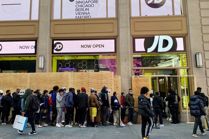 People wait in line outside for their turn to enter the JD Sports store in New York City on Nov. 5.