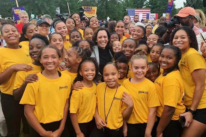 Kamala Harris poses with the Isiserettes, a legendary drill-and-drum team, at the Polk County Steak Fry in Iowa in 2019.