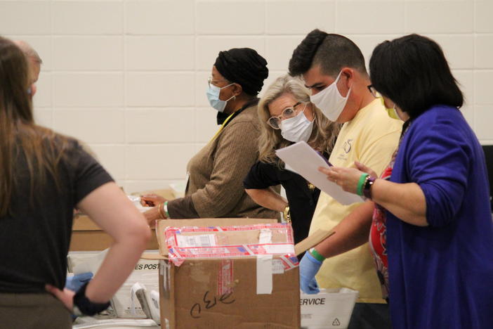 Election workers examine ballots Friday in Cobb County in metro Atlanta as part of a statewide recount of the presidential race.