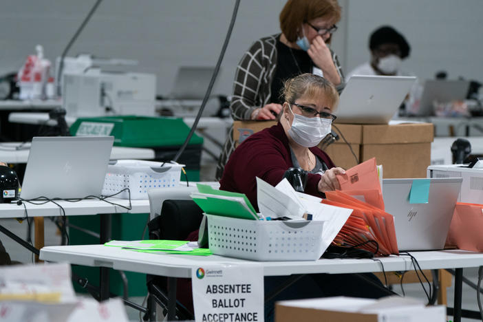 Election personnel sort ballots in preparation for an audit at the Gwinnett County Board of Voter Registrations and Elections offices on Saturday in Lawrenceville, Ga. President Trump's attempt at legal action to contest the results of the election have so far been mostly unsuccessful.