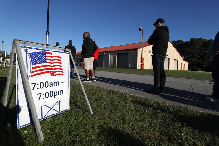 Voters line up at Gwinnett County Fairgrounds last month in Lawrenceville, Ga., to cast their ballot on the final day of early voting in Georgia.