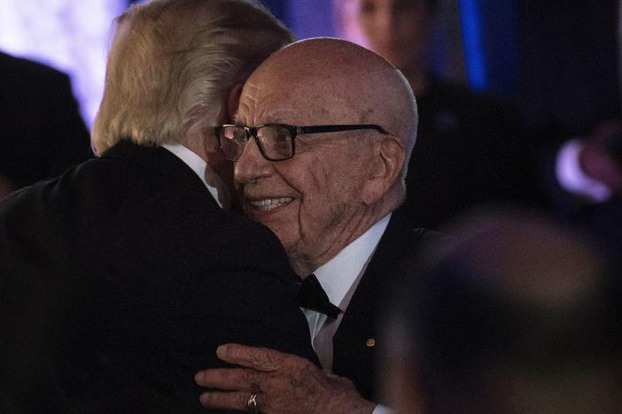 President Trump embraces Rupert Murdoch, co-chairman of Fox Corp., at a dinner in 2017. Once close, Trump is now angry at Murdoch's Fox News over its election coverage.