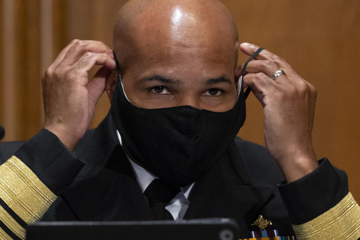 Surgeon General Jerome Adams, pictured on Capitol Hill on Sept. 9, says the Trump administration coronavirus task force is sharing information with "everyone," despite claims that they are not sharing information with the Biden transition team.
