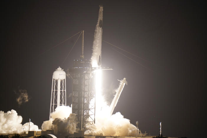 A SpaceX rocket, with the Crew Dragon capsule attached, lifts off from Kennedy Space Center Sunday in Cape Canaveral, Fla.