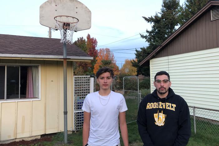 Antonio Jimenez (L) and his father Antonio Garcia at their home in Portland, Ore. Jimenez, a 16-year-old high school junior, has been trying to develop his basketball skills during the pandemic by training in small groups with other players and shooting several hundred jump shots daily at home.