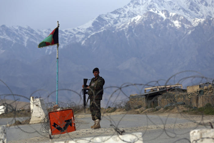 An Afghan National Army soldier stands guard at a checkpoint near the Bagram airfield, the largest U.S. military base in Afghanistan, in April.