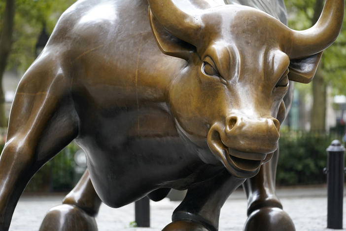 The Charging Bull statue is shown in New York's financial district. The Dow surpassed 30,000 points for the first time after President Trump allowed the transition process to begin.