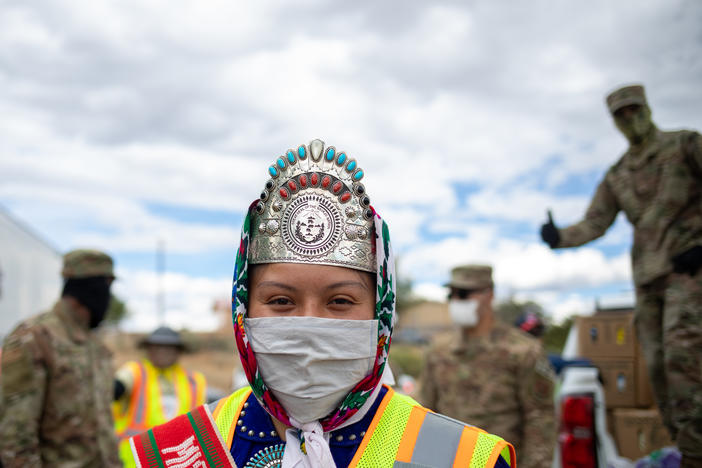 Miss Navajo Nation Shaandiin P. Parrish puts on a white gown to help distribute food, water, and other supplies to Navajo families on May 27, 2020 in Huerfano on the Navajo Nation Reservation, New Mexico.