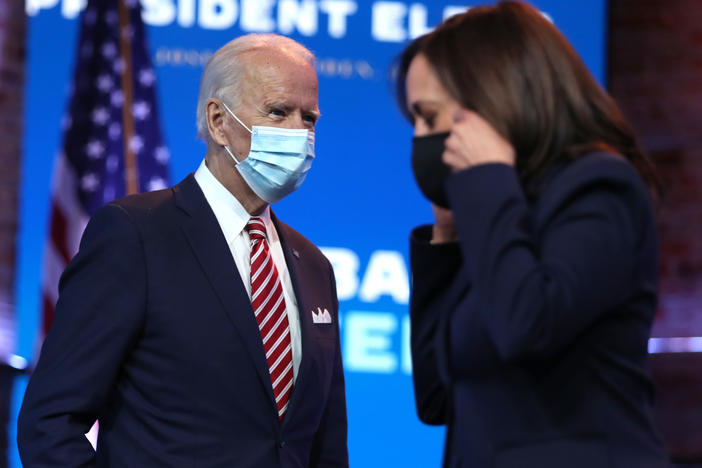 President-elect Joe Biden walks by Vice President-elect Kamala Harris before delivering remarks on his plan for economic recovery under his incoming administration.
