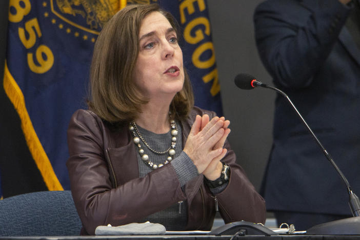 Oregon Gov. Kate Brown (shown here on Nov. 10) has ordered new statewide restrictions to head off a resurgence in coronavirus cases.