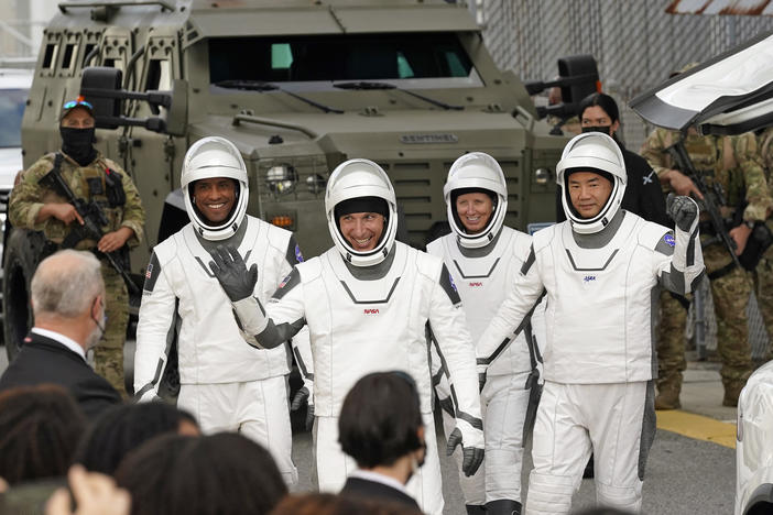 Astronauts (from left) Victor Glover, Michael Hopkins, Shannon Walker and Japan's Soichi Noguchi wave to family and friends as they leave for the launch site on Sunday.