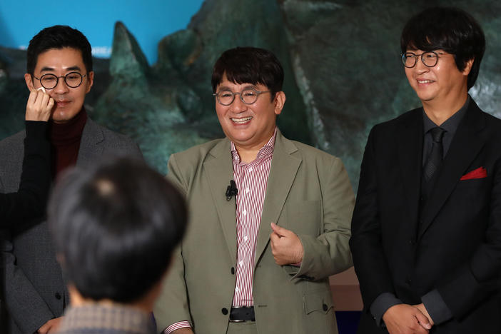 Chairman and CEO Bang Si-hyuk, center, photographed Oct. 15, 2020, the day his company, Big Hit Entertainment, debuted on the Korea Exchange in Seoul. To his left, Jiwon Park, Big Hit CEO of HQ & Management; right, Lenzo Yoon Big CEO of Global & Business.