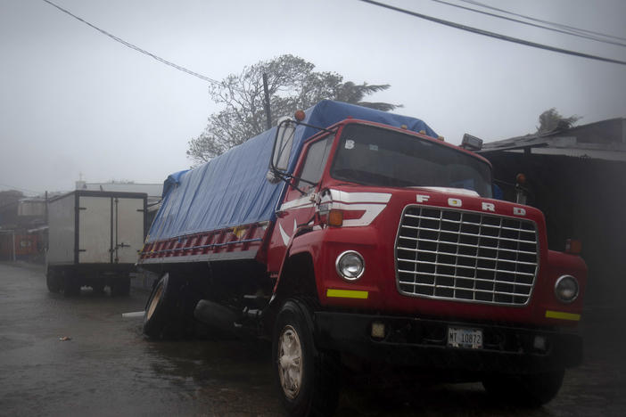 A truck flounders in a flooded street in Puerto Cabezas, Nicaragua, just hours before Hurricane Iota made landfall in the country Monday night. By Tuesday morning, the storm had significantly weakened, but it still poses life-threatening dangers for residents in its path.